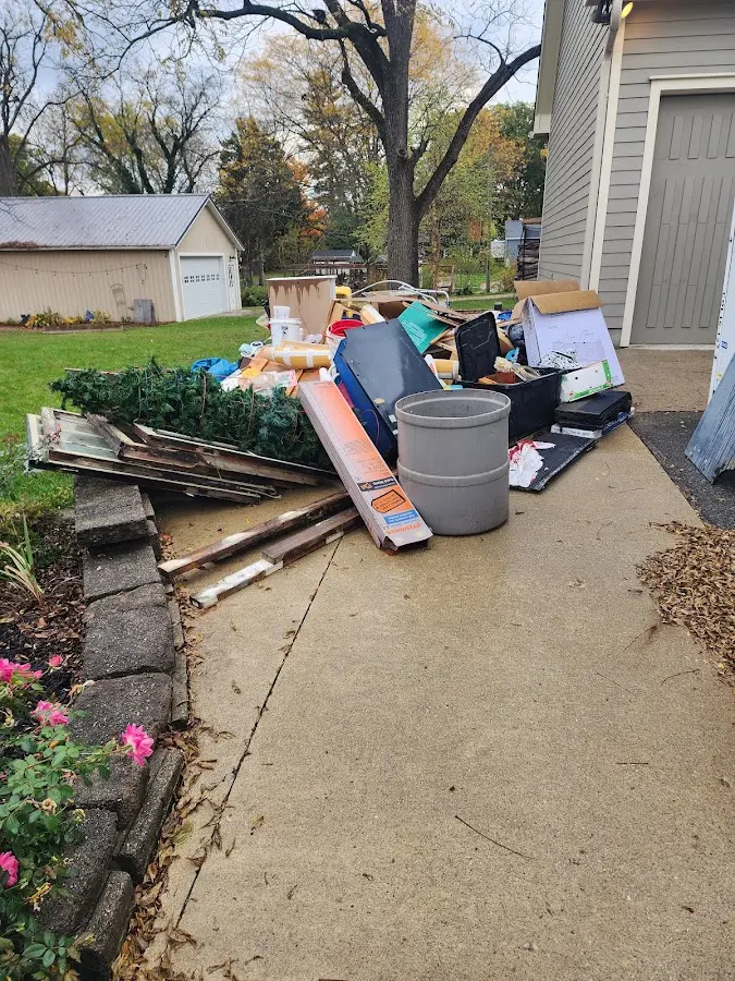 Dumpster being loaded with debris for Roofing Dumpster Rental in Bar Harbor